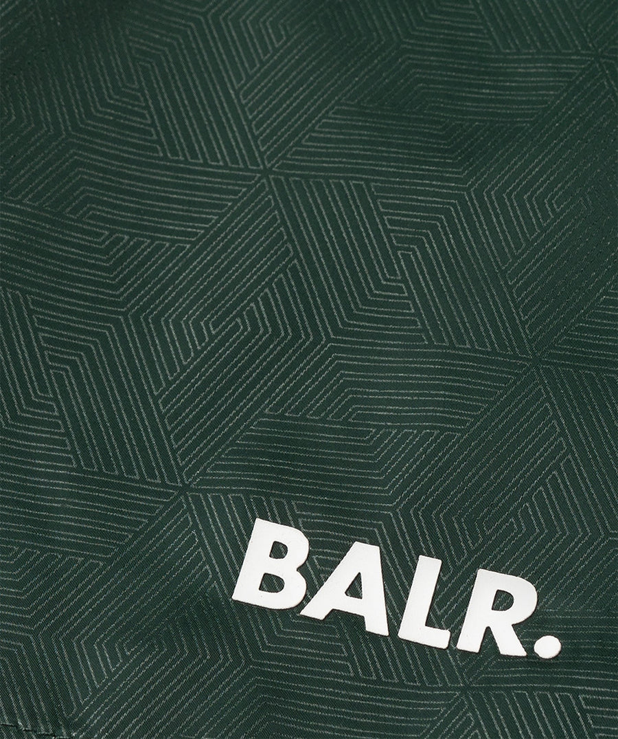 BALR Monogram Swim Shorts B1451.1034 – premium swim shorts featuring an all-over BALR monogram print, an elasticated waistband with a drawcord, and two zippered pockets. Made from lightweight, quick-drying fabric for ultimate comfort and style by the water.