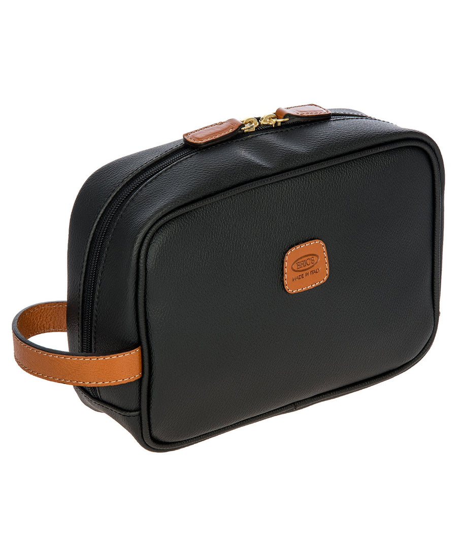 Bric's black leather toiletry bag with brown leather accents, gold-tone double zipper closure, side handle, and 'Made in Italy' logo patch, style code BBJ00601.001.