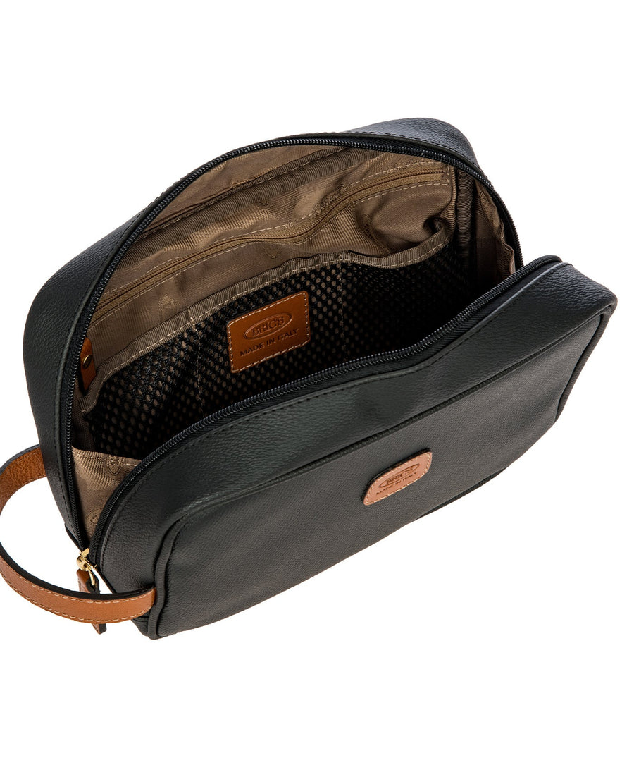 Bric's black leather toiletry bag with brown leather accents, gold-tone double zipper closure, side handle, and 'Made in Italy' logo patch, style code BBJ00601.001.