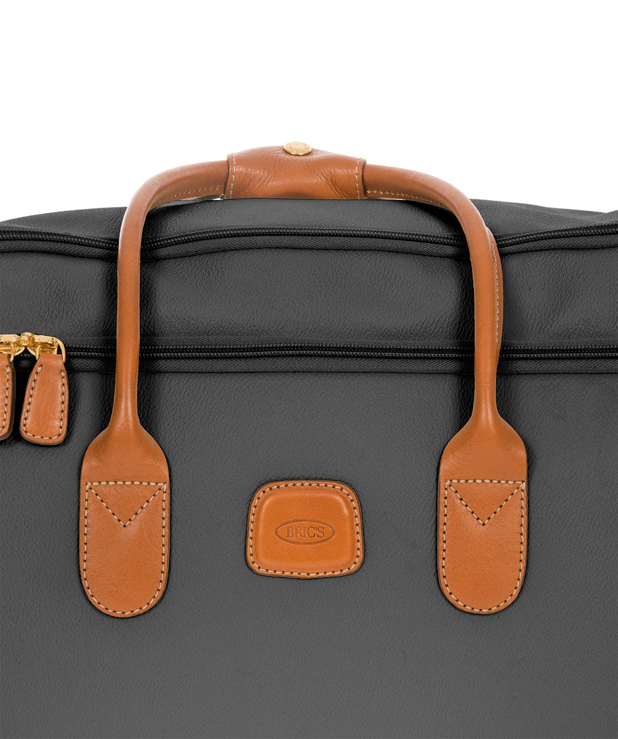 Bric's 21" Firenze rolling duffel bag in black with brown leather handles, gold-tone zippers, and telescopic pull handle, featuring Bric's 'Made in Italy' logo, style code BBJ15220.