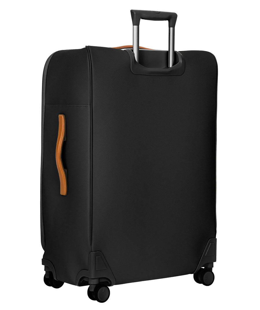 Bric's black 32" Firenze Trolley checked spinner suitcase with brown leather accents, front zip pocket, gold-tone zippers, telescopic handle, and 360° spinner wheels, style code BBJ15291.